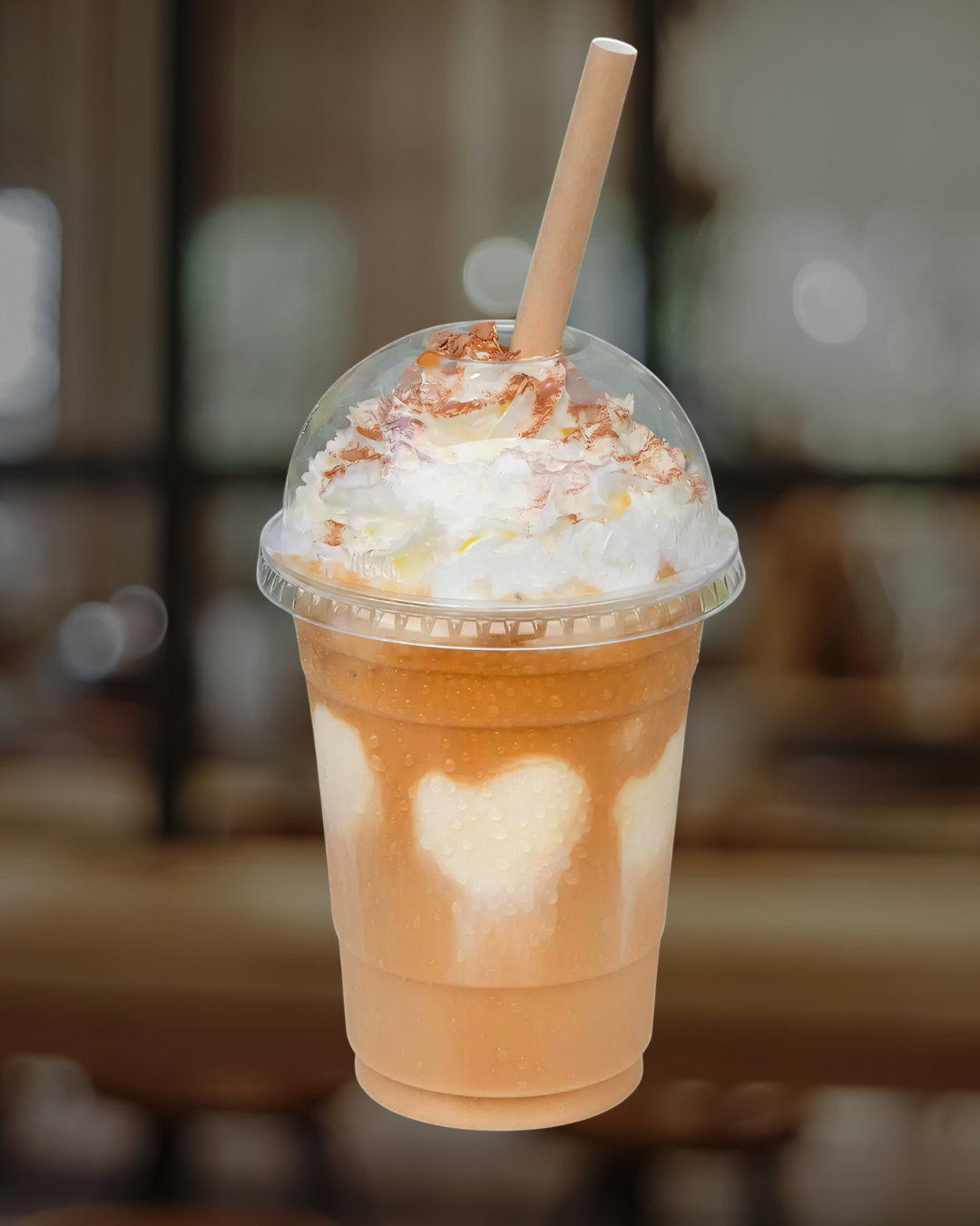 Iced blended drink topped with whipped cream and caramel